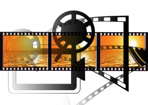 Bild: Filmstreifen mit Filmspule und Projektor