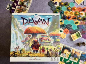 Die Spieleschachtel liegt auf einem Teil des bunten Spielmaterials.